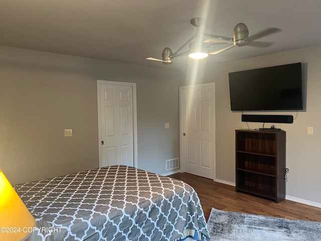 bedroom with ceiling fan and hardwood / wood-style flooring