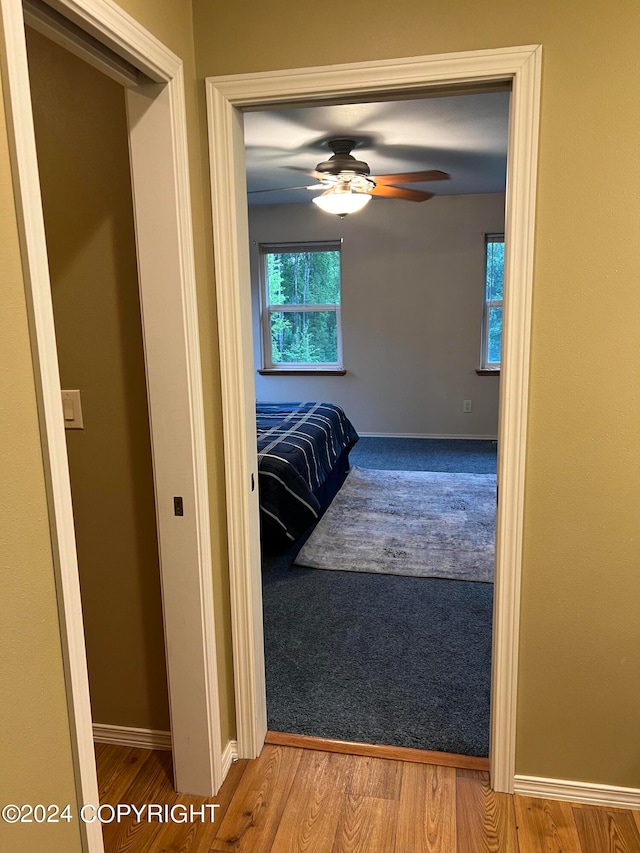 bedroom with hardwood / wood-style floors and ceiling fan