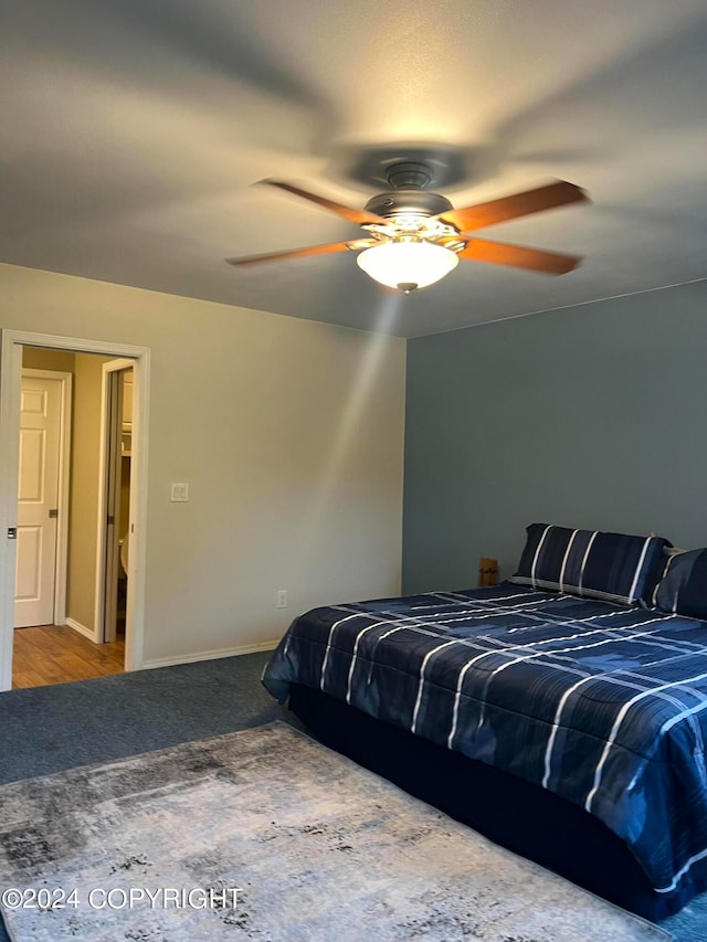 bedroom featuring ceiling fan and hardwood / wood-style flooring