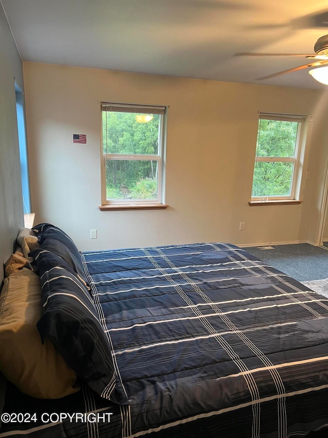 carpeted bedroom featuring ceiling fan