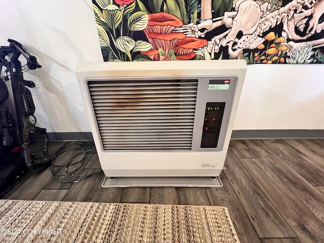 details with heating unit and hardwood / wood-style flooring