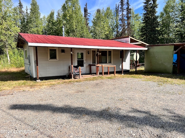 single story home featuring covered porch