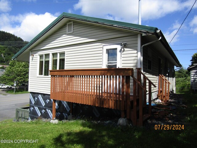 rear view of house featuring a deck