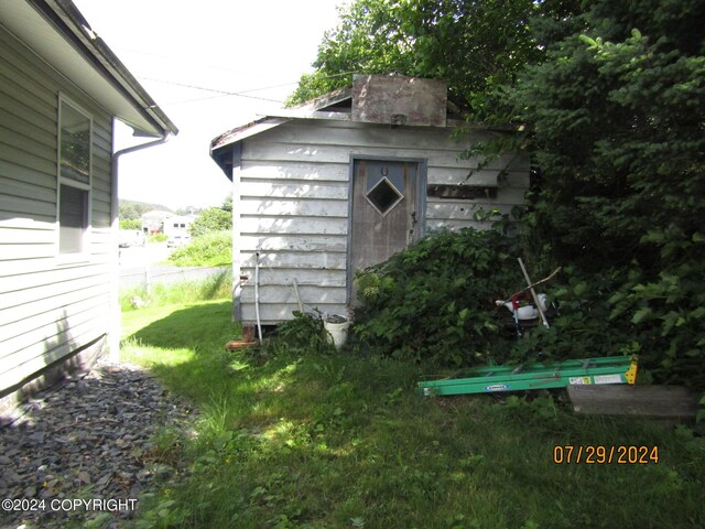 view of outbuilding featuring a yard