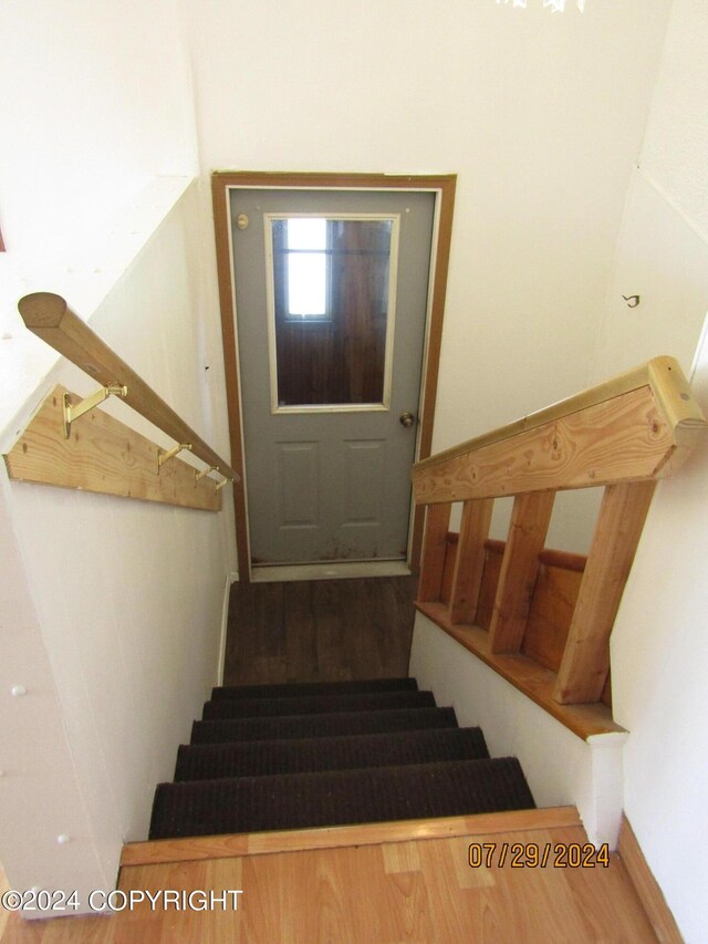 staircase featuring hardwood / wood-style flooring