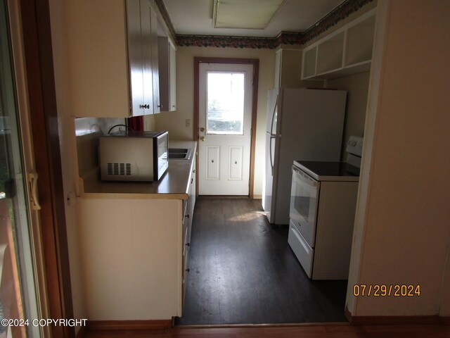 kitchen featuring white electric stove and dark hardwood / wood-style flooring