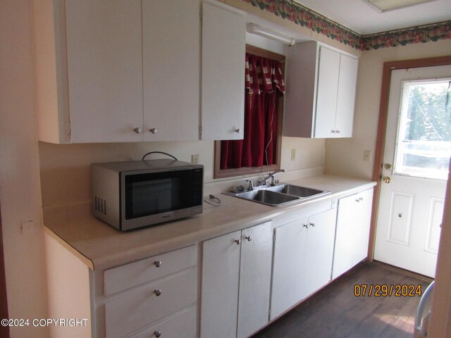 kitchen featuring sink and white cabinets