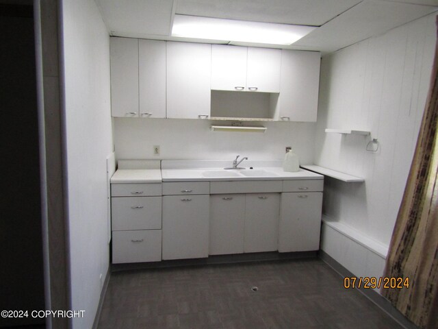 kitchen featuring white cabinets and sink