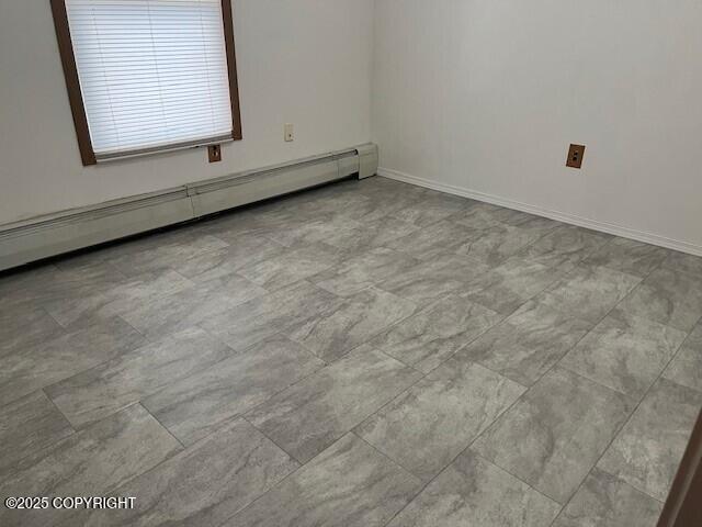 empty room with a baseboard heating unit