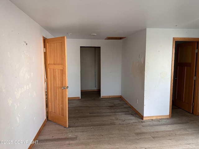 spare room with visible vents, baseboards, and wood finished floors