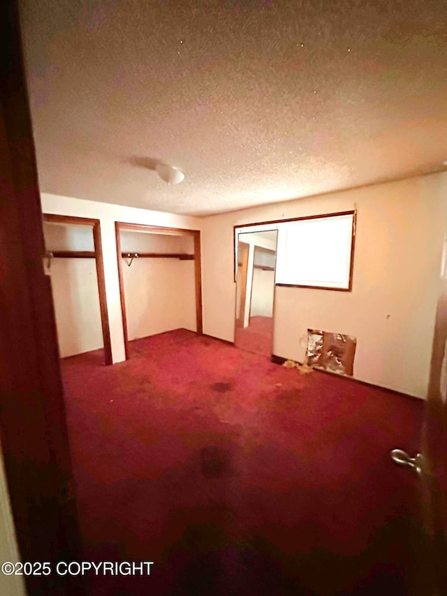 unfurnished bedroom featuring carpet flooring and a textured ceiling