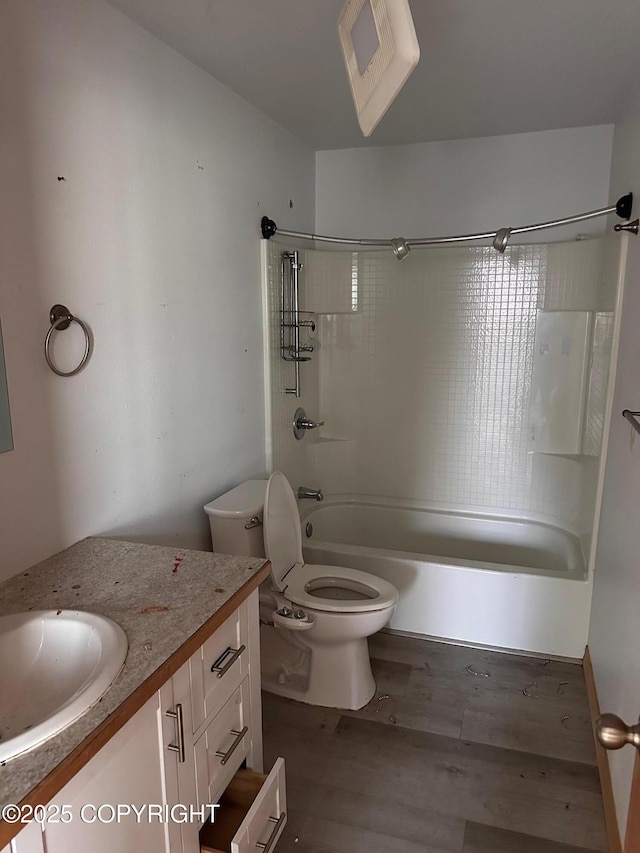 full bathroom featuring toilet, vanity, bathtub / shower combination, and wood finished floors