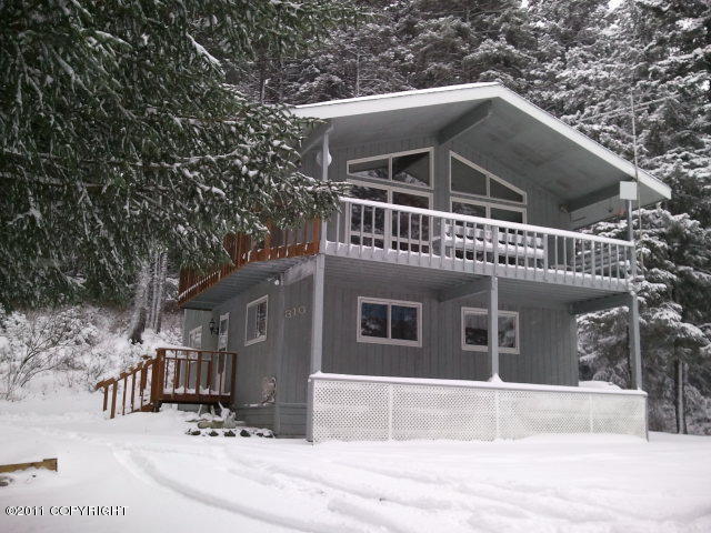 snow covered property with a balcony