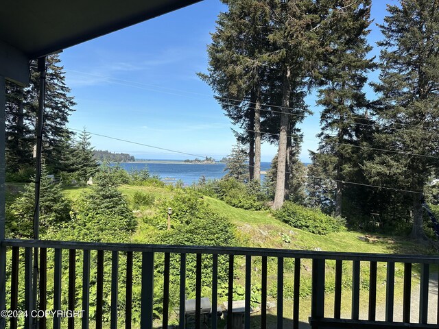 exterior space featuring a balcony and a water view