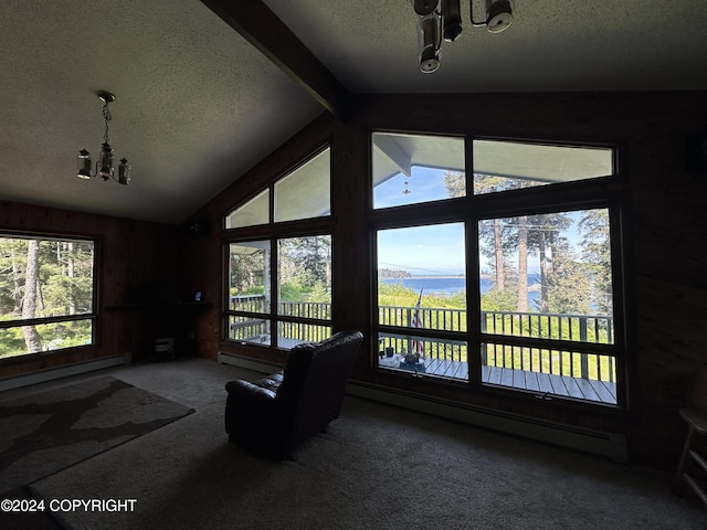 unfurnished living room with baseboard heating, carpet flooring, lofted ceiling with beams, and a chandelier