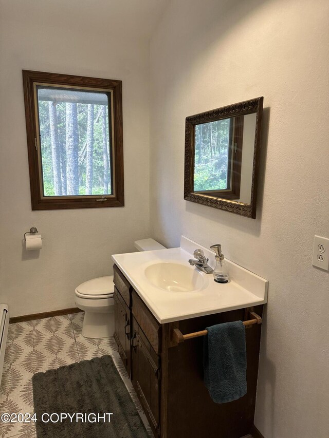 bathroom featuring tile patterned floors, vanity, and toilet