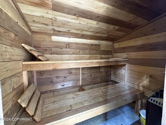 view of sauna with wood walls and wooden ceiling