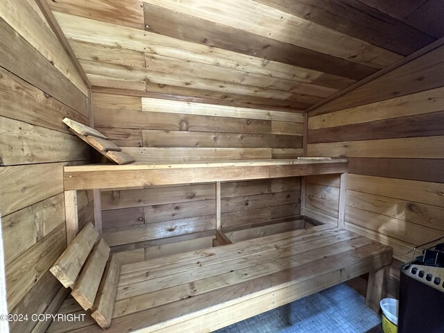 view of sauna / steam room featuring wood ceiling and wood walls