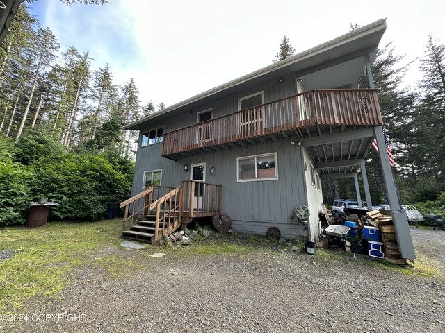 back of property featuring a balcony