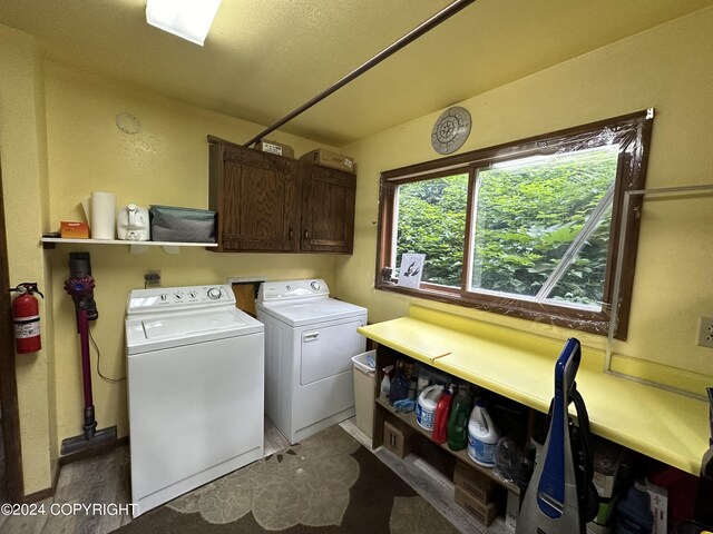 laundry area with washing machine and dryer and cabinets