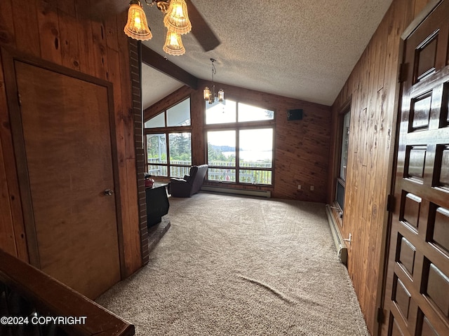 interior space featuring vaulted ceiling with beams, wooden walls, an inviting chandelier, carpet, and a textured ceiling