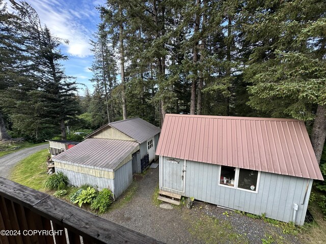 view of home's exterior featuring an outbuilding