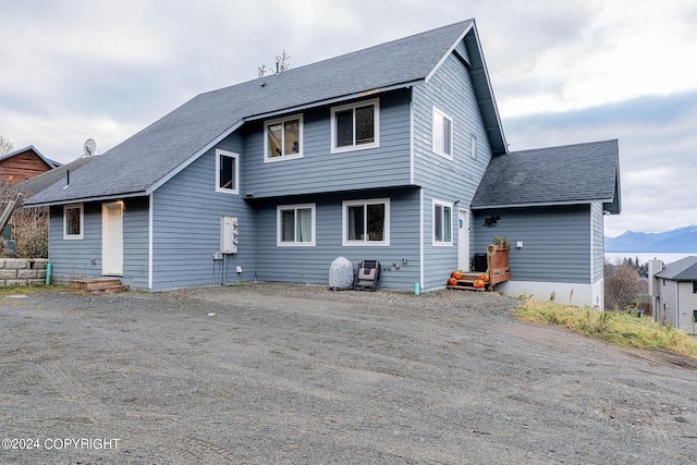 back of house with a mountain view