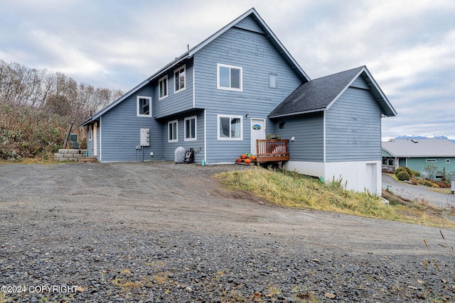 rear view of house with a wooden deck