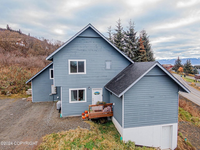 back of house with a deck with mountain view