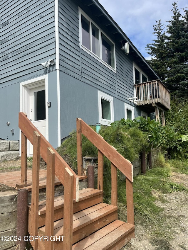 view of side of property with a wooden deck