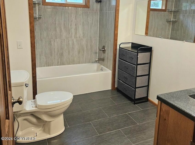 full bathroom with toilet, tiled shower / bath, and vanity