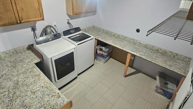 laundry room featuring cabinets and separate washer and dryer