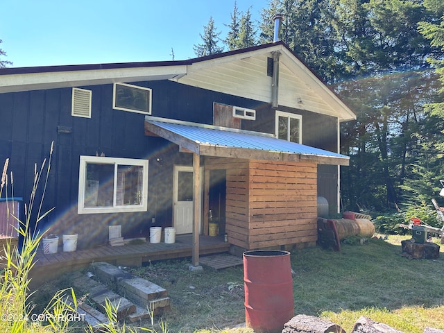 view of front facade with a wooden deck and a front lawn