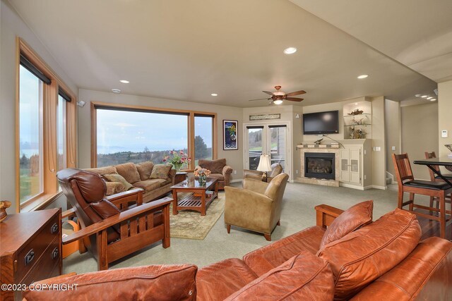 living room featuring light colored carpet and ceiling fan