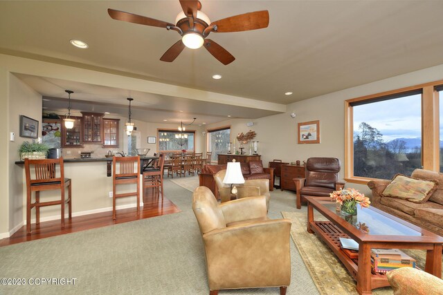 living room with a healthy amount of sunlight, light hardwood / wood-style floors, and ceiling fan