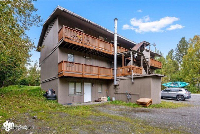 back of property with a balcony