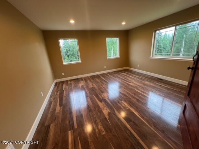 unfurnished room featuring hardwood / wood-style flooring and a wealth of natural light