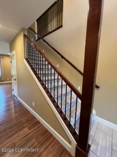 stairway featuring hardwood / wood-style floors