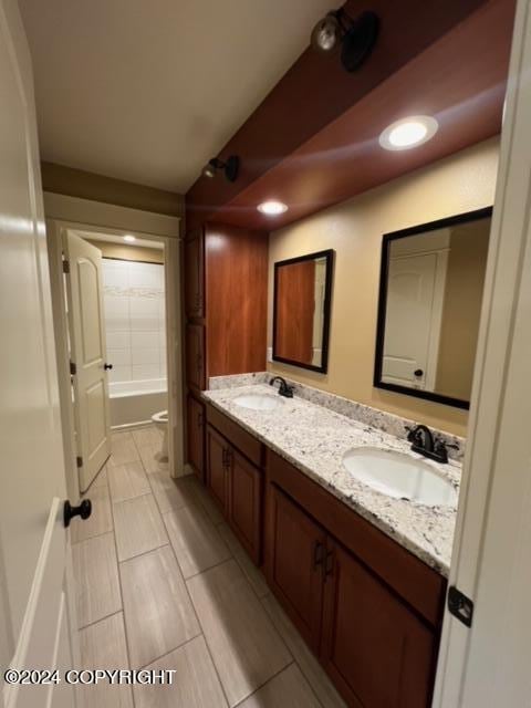 bathroom with bathtub / shower combination, tile patterned flooring, and double sink vanity