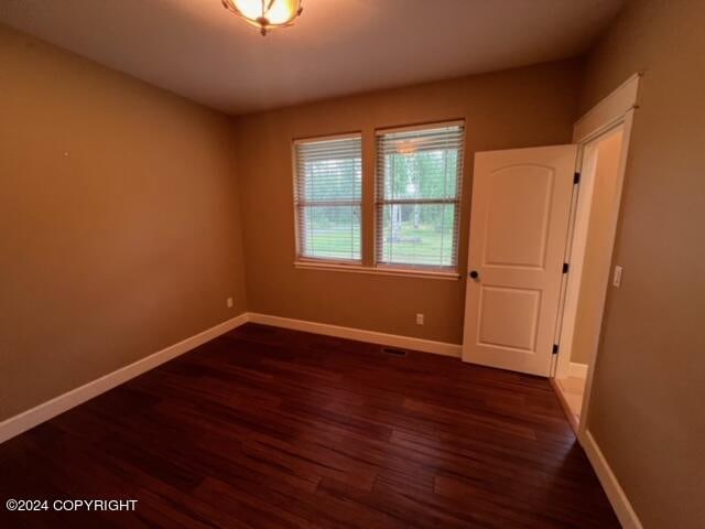 spare room featuring dark hardwood / wood-style flooring