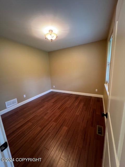 empty room featuring dark hardwood / wood-style flooring