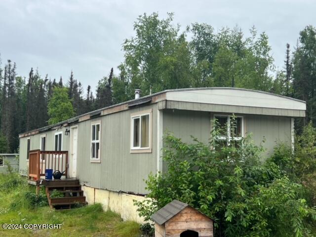 rear view of property featuring a deck