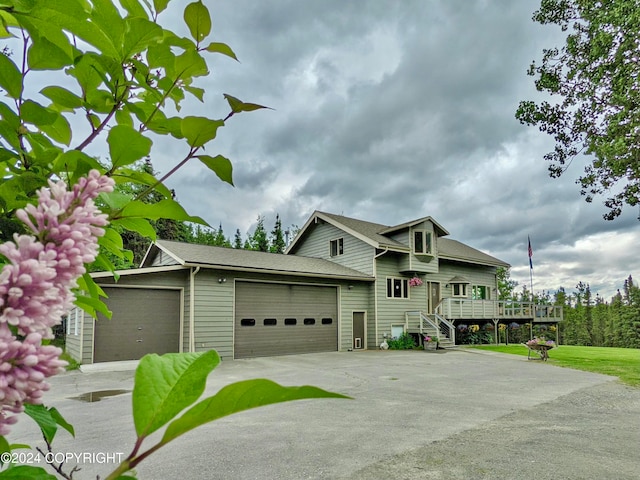 view of front of home featuring a garage and a wooden deck