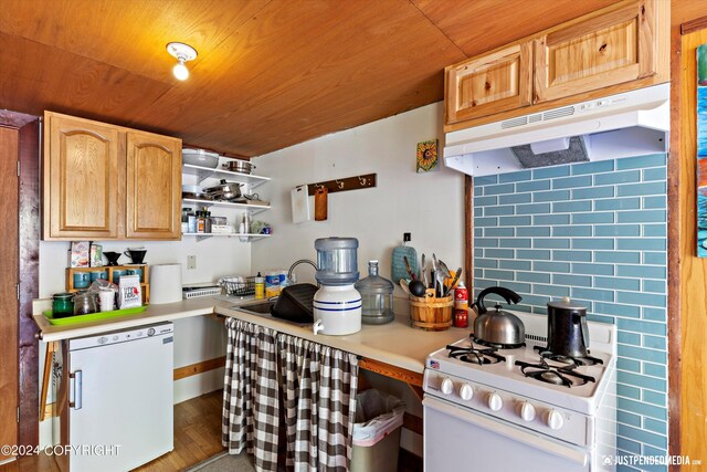 kitchen with decorative backsplash, white appliances, light brown cabinetry, and hardwood / wood-style flooring