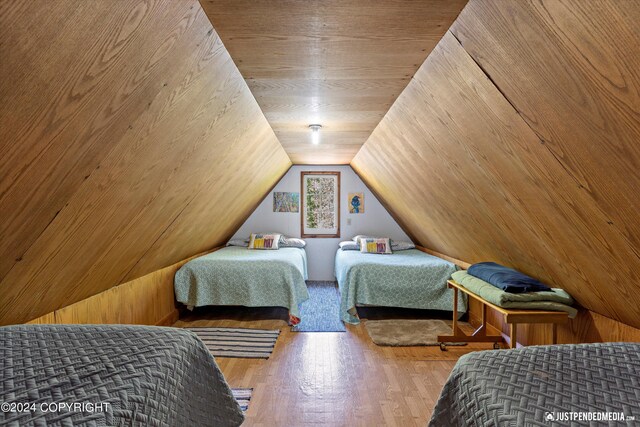 bedroom featuring lofted ceiling and hardwood / wood-style floors