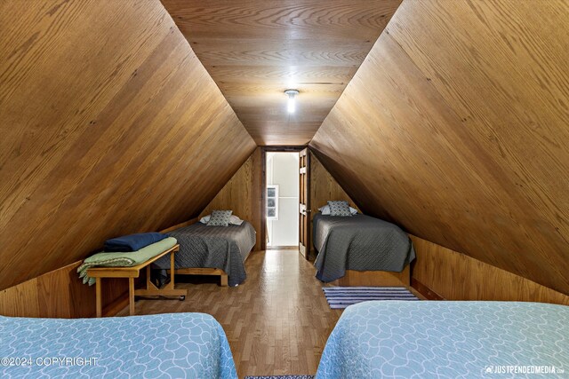 bedroom featuring lofted ceiling and hardwood / wood-style flooring