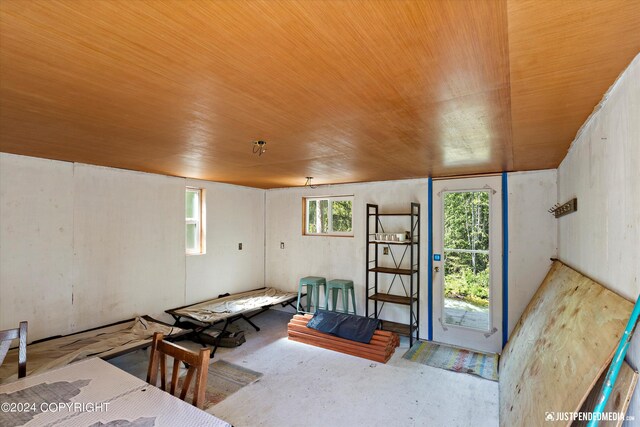 misc room with concrete flooring and wood ceiling