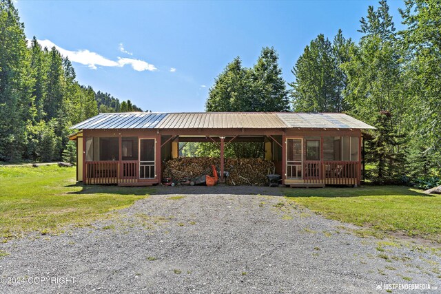 ranch-style home with a sunroom and a front yard