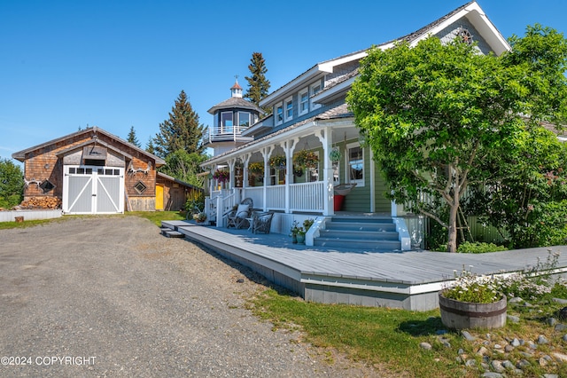 view of front facade with a porch and an outbuilding