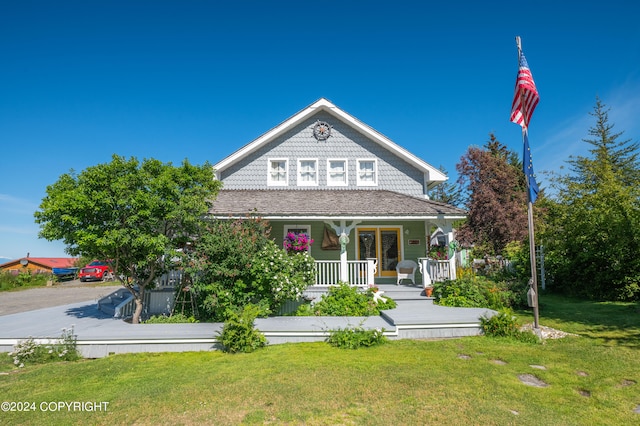 view of front of home with covered porch and a front yard